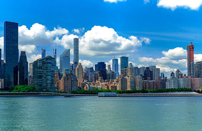 View of buildings in city against cloudy sky