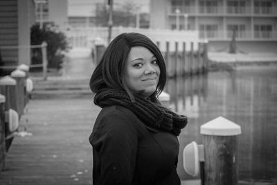 Portrait of smiling young woman by lake