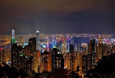 Illuminated hong kong cityscape against sky at night