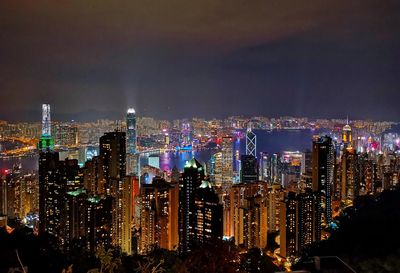 Illuminated cityscape against sky at night