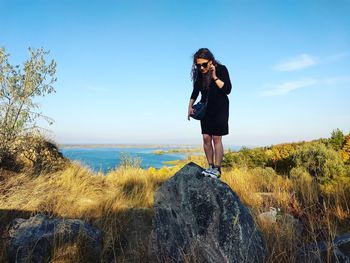 Woman standing on land against sky