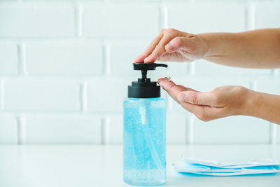 Close-up of hand holding glass bottle