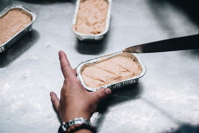 Cropped hands preparing food in kitchen