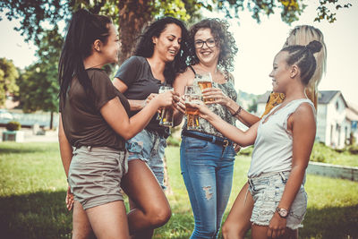 Happy young woman drinking glasses