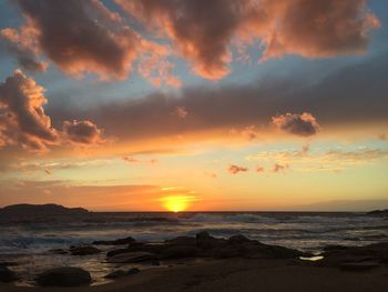 Scenic view of beach against sky during sunset