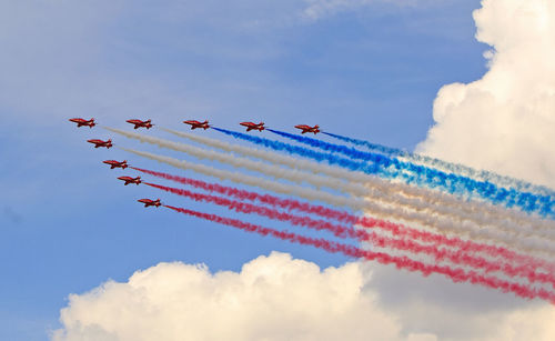 Low angle view of airshow against sky