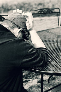 Stressed man huddled against a table