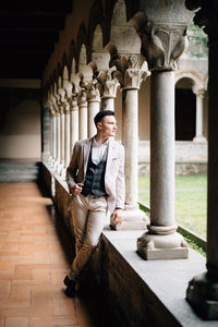 Full length portrait of man standing in building