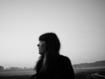 Defocused image of woman standing on field