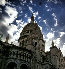 Low angle view of church against cloudy sky