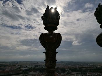 Low angle view of statue against buildings in city