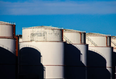 Low angle view of factory against blue sky