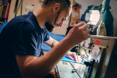 Man working on sewing machine