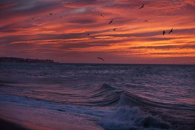 Scenic view of sea against orange sky