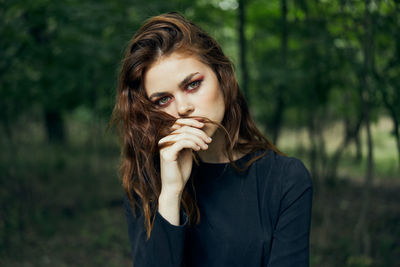 Portrait of young woman in forest