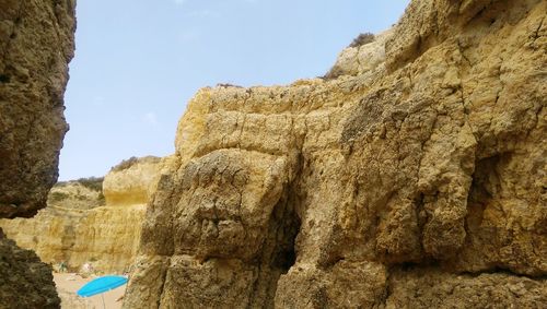 Close-up of rock formation against sky