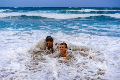 Brothers enjoying in sea