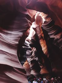 People standing amidst antelope canyon