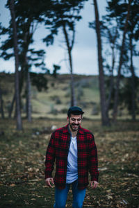 Portrait of young man standing on field