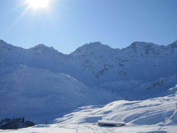 Scenic view of snowcapped mountains against clear sky