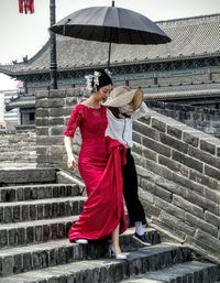 Full length of woman standing by railing