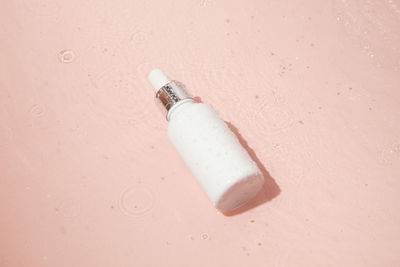 Close-up of light bulb against yellow background