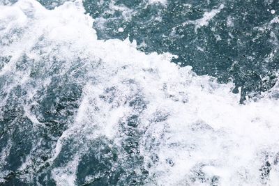 High angle view of waves splashing on sea