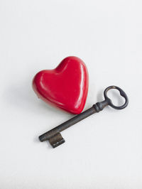 High angle view of red heart shape over white background