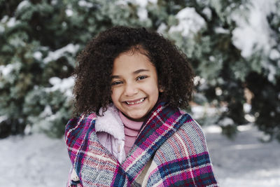 Portrait of smiling woman in snow