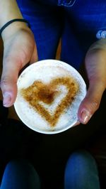 Close-up of hand holding coffee cup