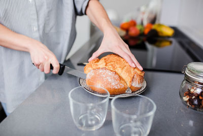 Midsection of woman preparing food at kitchen