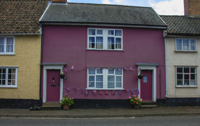 A colourful house with union flag bunting to celebrate the queen's platinum jubilee in eye, uk