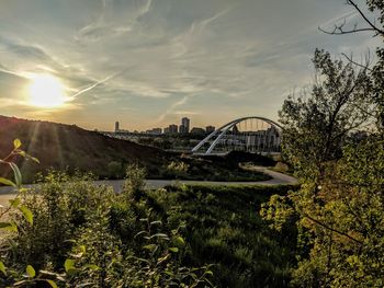 Arch bridge against sky during sunset