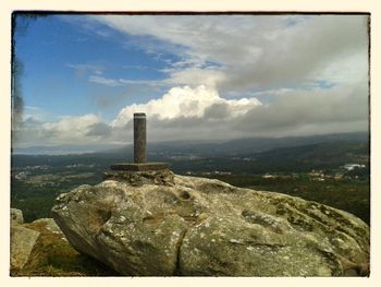 Scenic view of landscape against cloudy sky