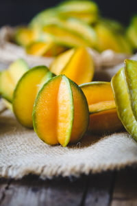 Close-up of starfruits with burlap on table