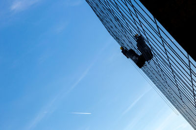 Low angle view of buildings against blue sky