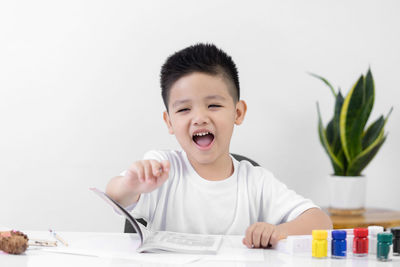 Portrait of cute boy sitting at home