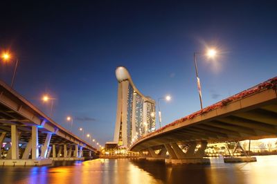 Suspension bridge over river at night
