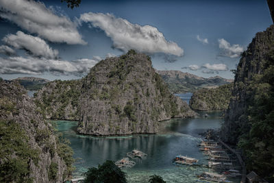 Scenic view of river amidst trees against sky