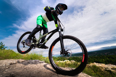 Low angle view of man riding bicycle