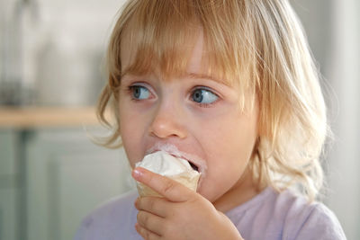 Close-up of boy eating food at home