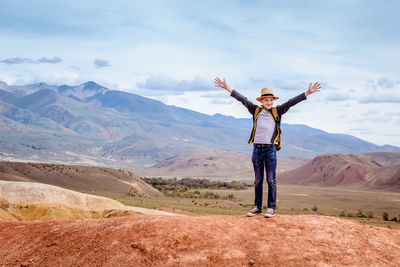 Full length of man standing on mountain against sky