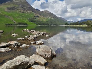 Scenic view of lake and mountains against sky