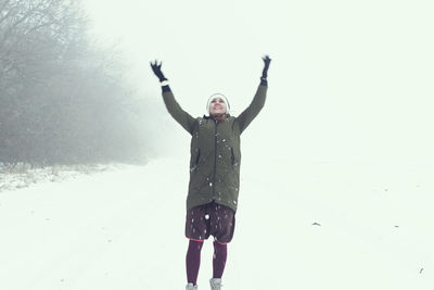 Full length of woman standing on snow