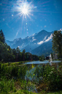 Scenic view of lake by mountains against sky