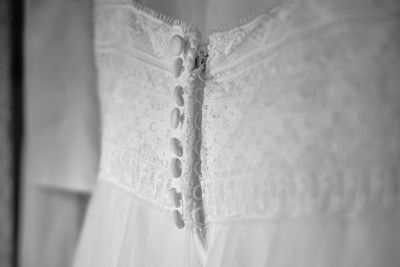 Close-up of clothes hanging on white fabric