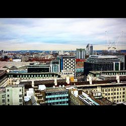 Buildings against cloudy sky