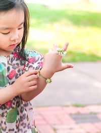 Close-up of girl holding hands