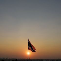 Low angle view of flag against sky during sunset