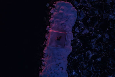 Close-up of rock against sky at night